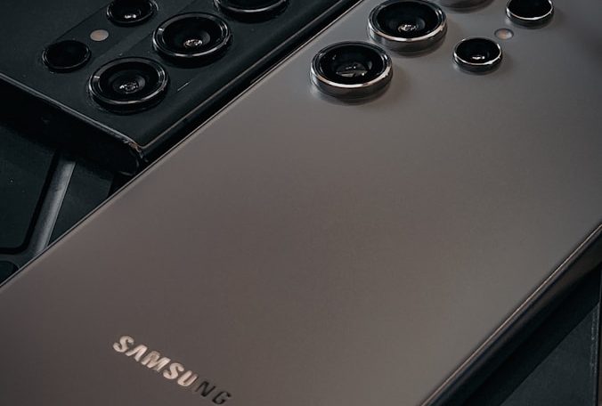 a close up of a cell phone near a keyboard